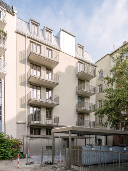 Innenhofansicht des Wohnhauses an der Stollbergstraße. Moderne Balkone und ein überdachter Fahrradstellplatz sind im Fokus..